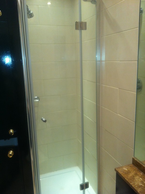 Frameless glass shower enclosure with chrome fittings in Charlton