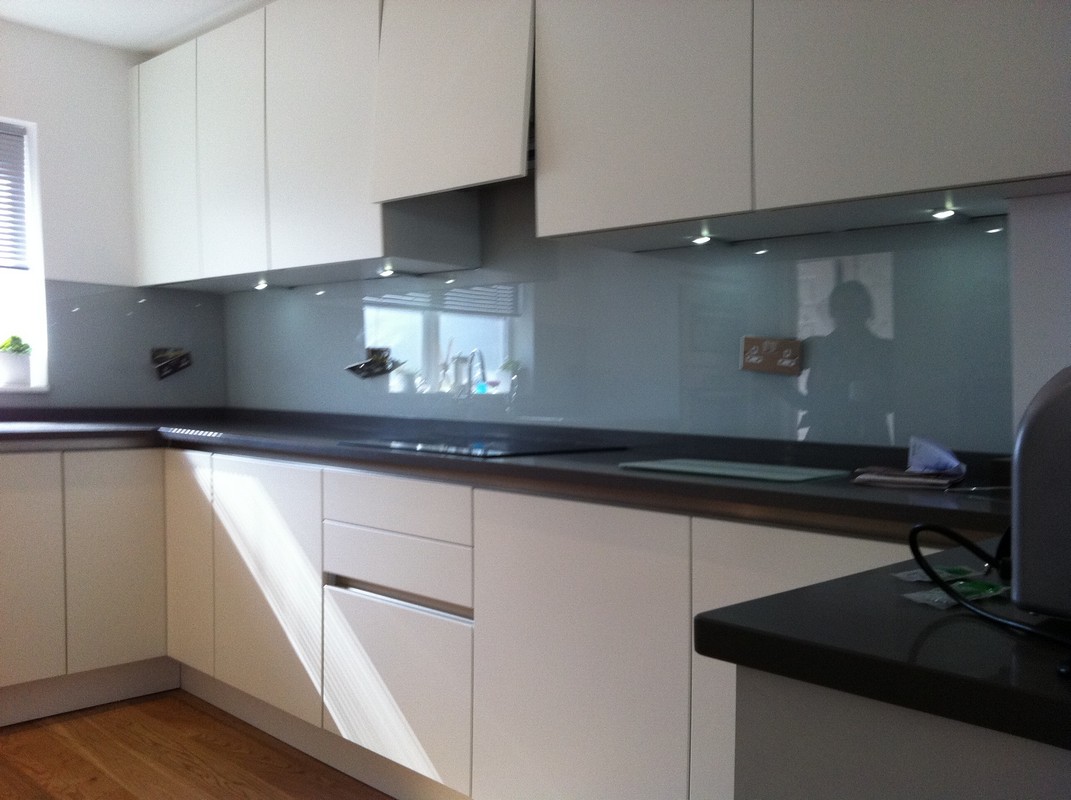 Grey glass kitchen splashback with LED lighting in Charlton