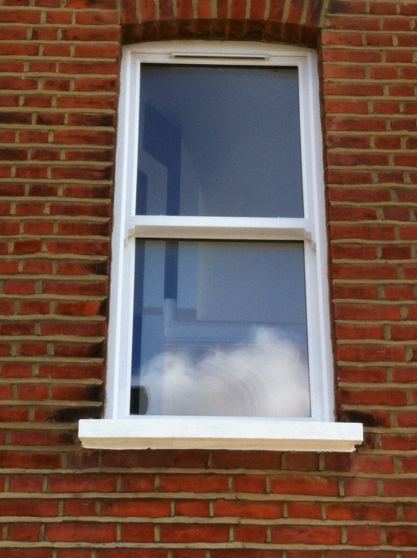 uPVC sash window on Victorian red brick house in Charlton